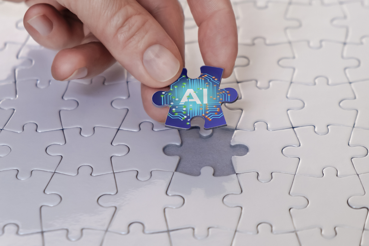 business person places AI puzzle piece to represent the concept of AI in New Product Development