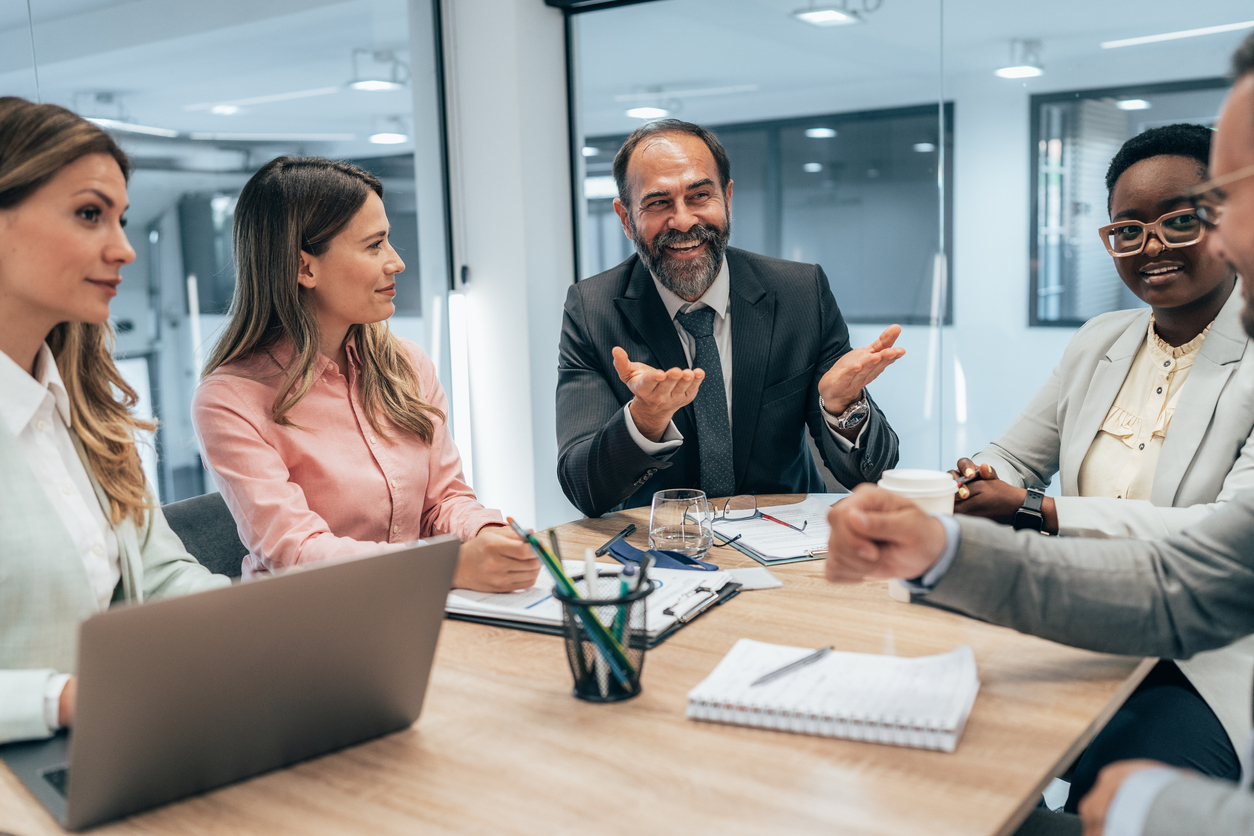 photo shows image of business team discussing new ideas about AI and customer engagement in office setting