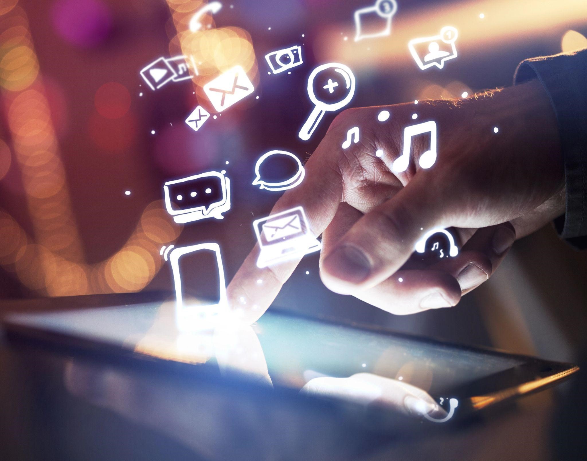 hand reaching for phone that has marketing and mobile icons levitating from it