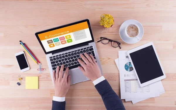 B2B buying process concept with professional working on laptop, analytics reports, and digital tools on a desk.