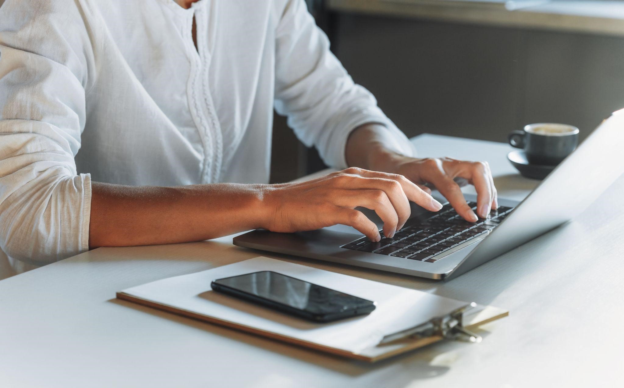 closeup woman hands typing on keyword after learning about AI and human creativity