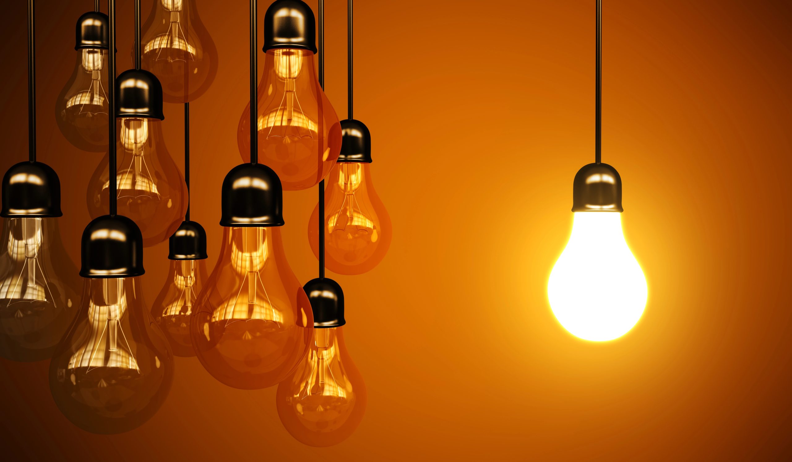 hanging light bulbs with orange background