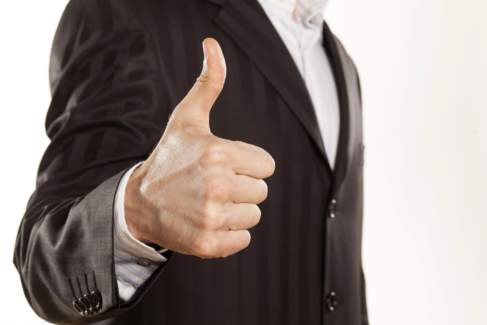 man in suit giving thumbs up