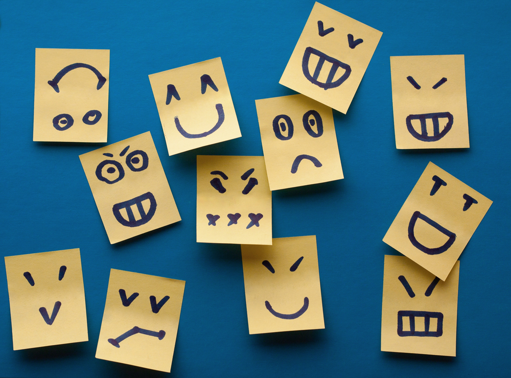 sticky notes with faces on them with blue background