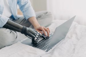 bionic and human hands use laptop computer to learn about B2B AI SEO audits