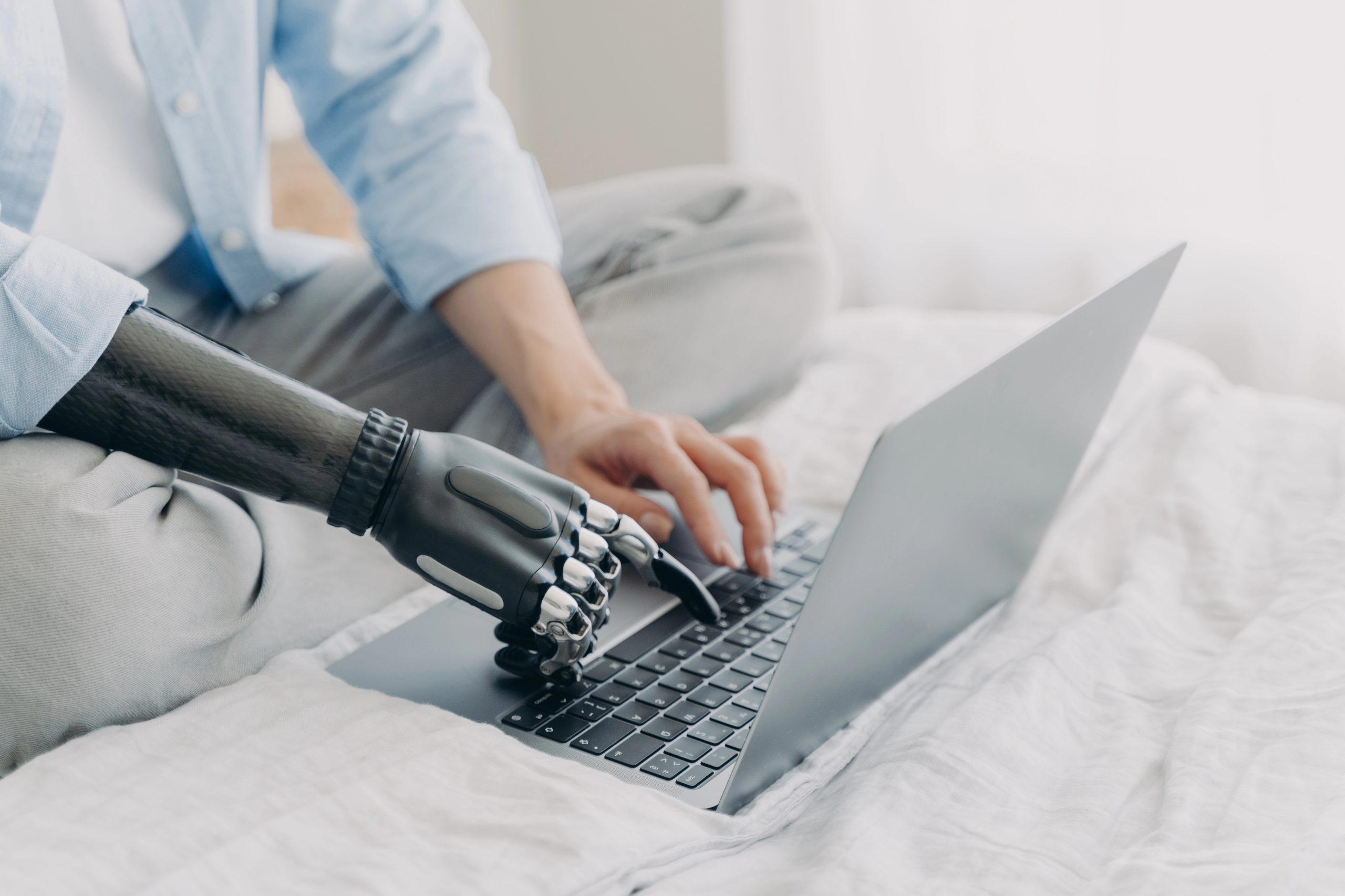 bionic and human hands use laptop computer to learn about B2B AI SEO audits